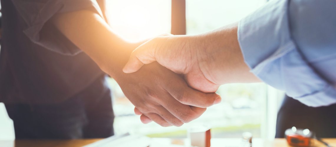 Business engineer team shaking hands to agree to joint business agreements in the future. About the creation of real estate and housing projects for government projects.